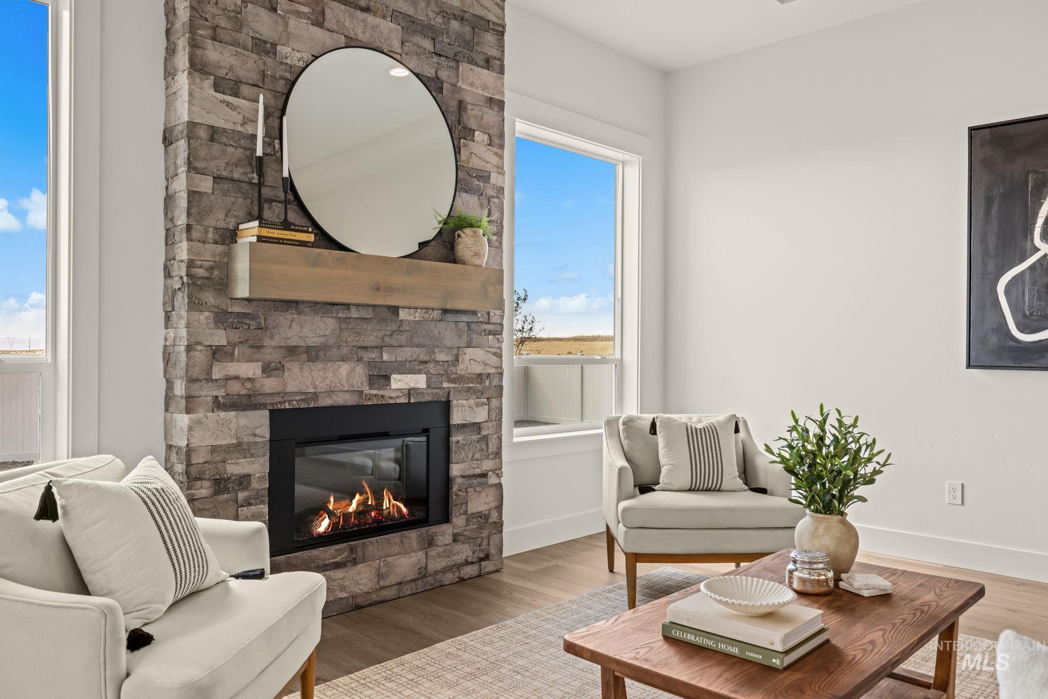 345 South Strut Way Boise, ID 83716 - Photo 21 of 50 Stone-clad fireplace with a wood mantel, gas insert, and large windows