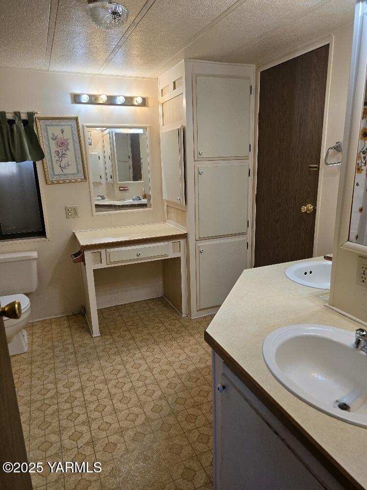 101 Ahtanum Road, Unit 2 Yakima, WA 98903 - Photo 11 of 15 a bathroom with a sink a toilet and mirror