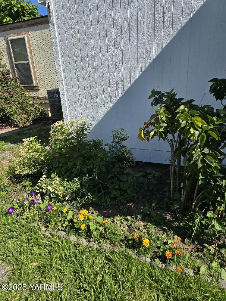 101 Ahtanum Road, Unit 2 Yakima, WA 98903 - Photo 3 of 15 a backyard of a house with a garden and plants