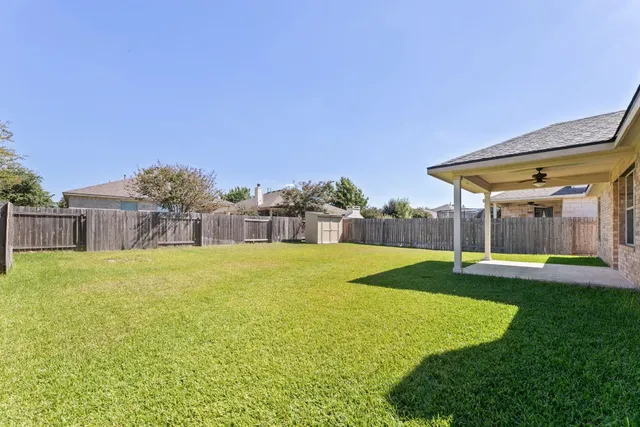 a front view of a house with yard and swimming pool