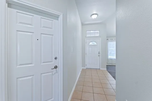 a view of an empty room with closet area