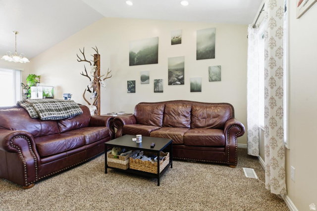 619 East 1st S Street, Unit S Preston, ID 83263 - Photo 4 of 16 Living area featuring a vaulted ceiling with recessed lighting, neutral wall tones, and a window with patterned drapes