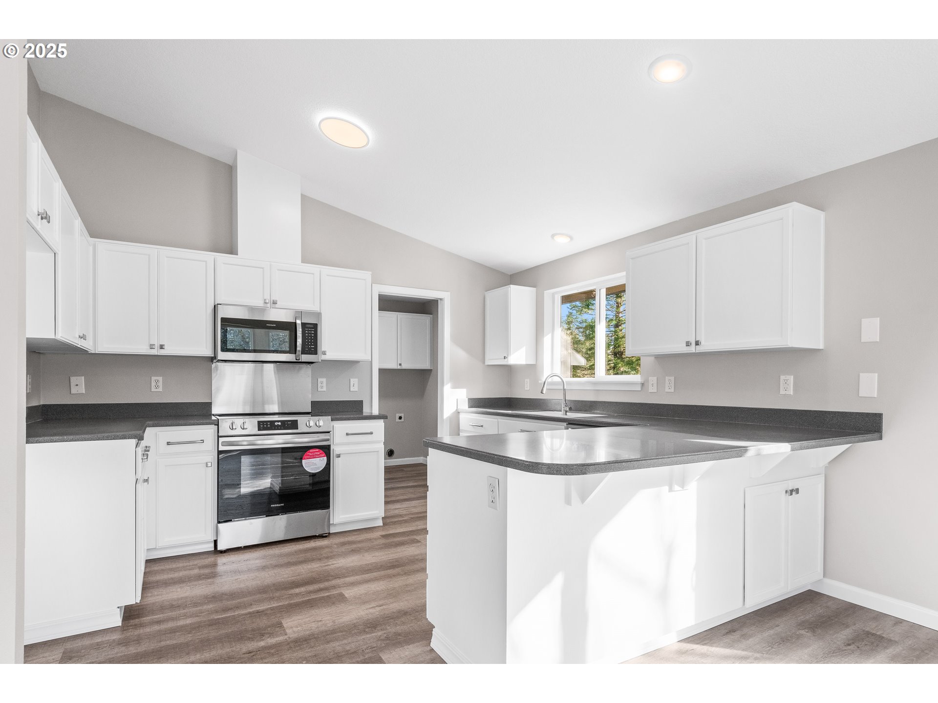 31030 Southwest Unger Road Cornelius, OR 97113 - Photo 18 of 25 a kitchen with stainless steel appliances kitchen island granite countertop a sink a stove top oven a counter space and cabinets