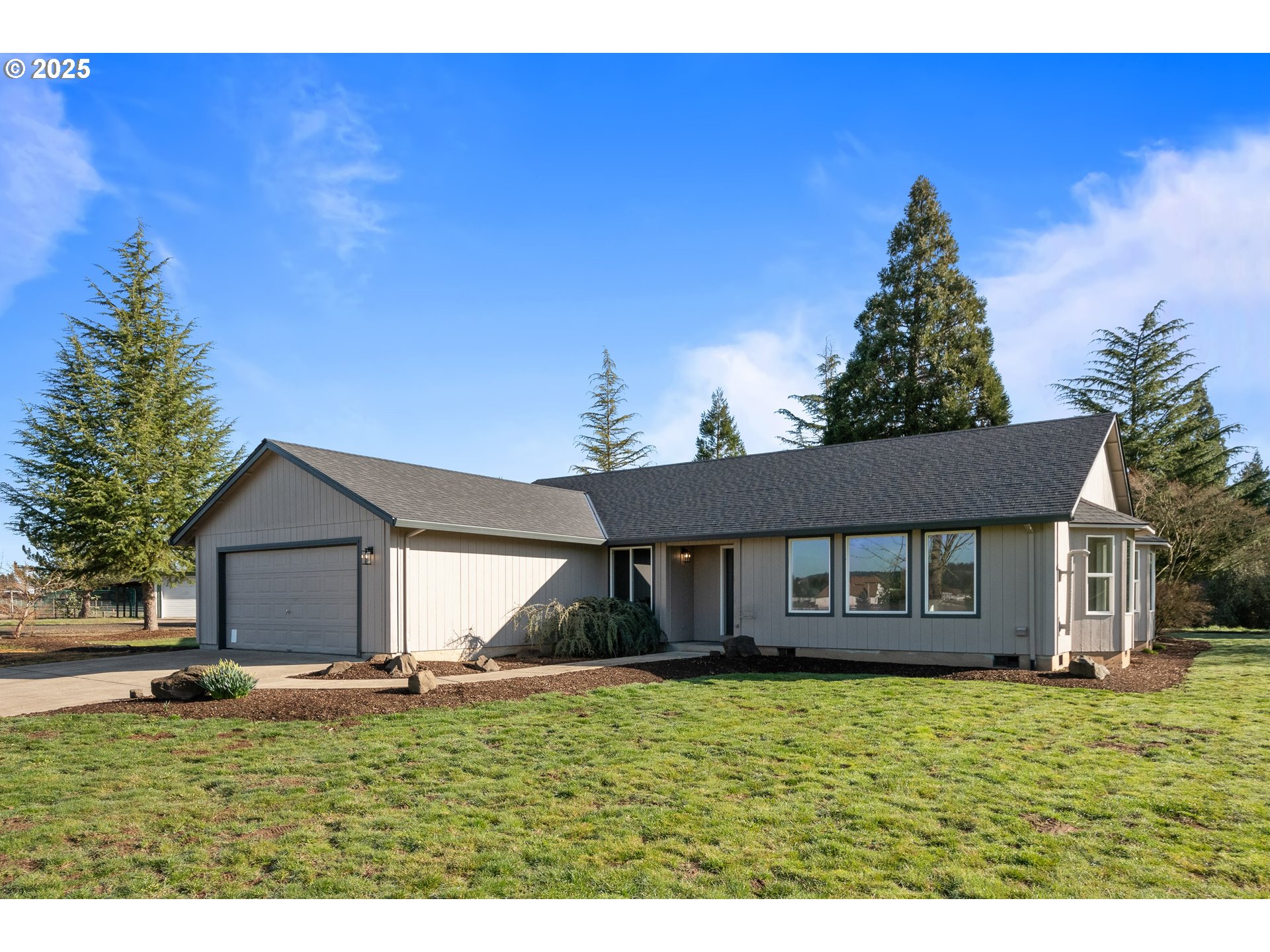 31030 Southwest Unger Road Cornelius, OR 97113 - Photo 2 of 25 a front view of a house with a garden