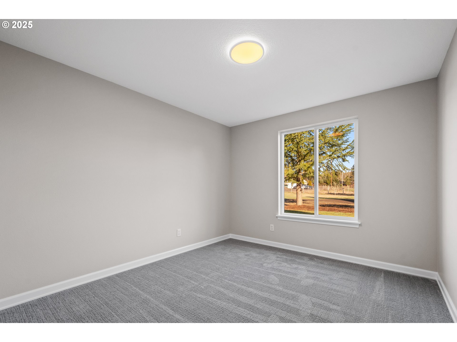31030 Southwest Unger Road Cornelius, OR 97113 - Photo 4 of 25 a view of an empty room with a window and wooden floor