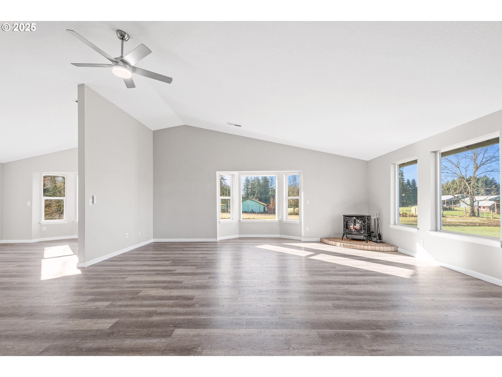 31030 Southwest Unger Road Cornelius, OR 97113 - Photo 6 of 25 a view of an empty room with window and wooden floor