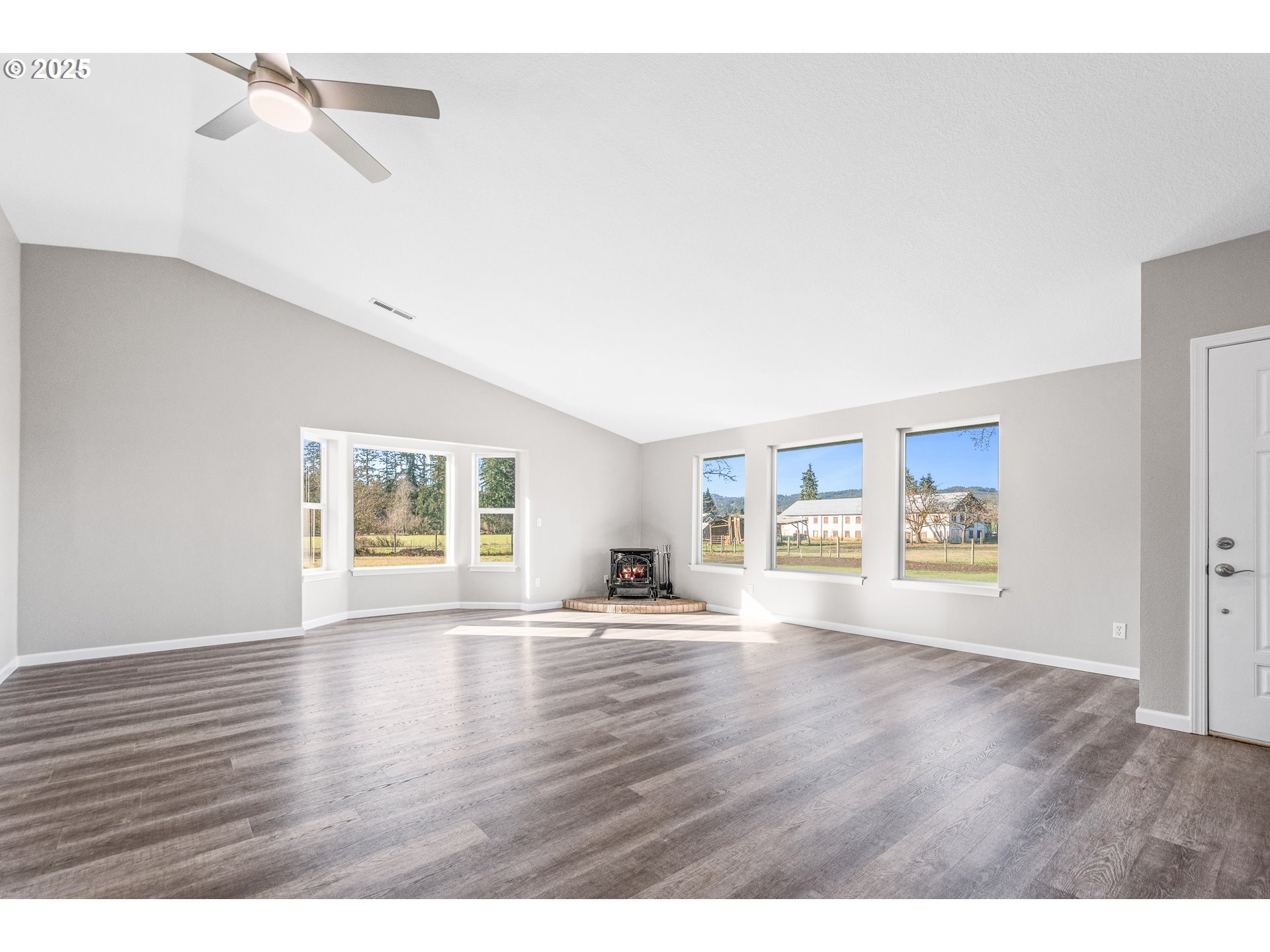 31030 Southwest Unger Road Cornelius, OR 97113 - Photo 7 of 25 a view of an empty room with a window and wooden floor