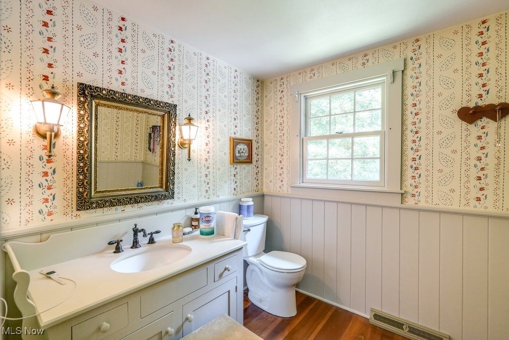 9699 Acme Road Rittman, OH 44270 - Photo 18 of 36 Bathroom featuring hardwood / wood-style flooring, vanity, and toilet