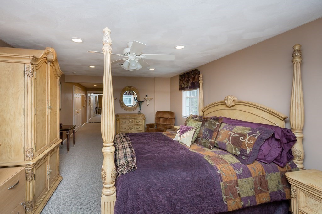 5 Williams Road Sharon, MA 02067 - Photo 11 of 34 a spacious bedroom with a large bed and a chandelier