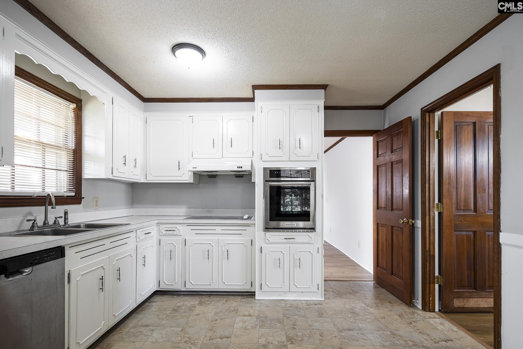 4083 Platt Springs Road West Columbia, SC 29170 - Photo 2 of 35 a kitchen with white cabinets and white appliances
