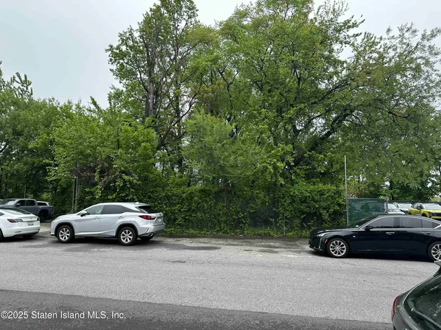 a view of car parked on the side of a street