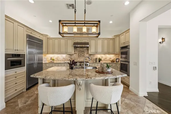 a kitchen with center island and stainless steel appliances