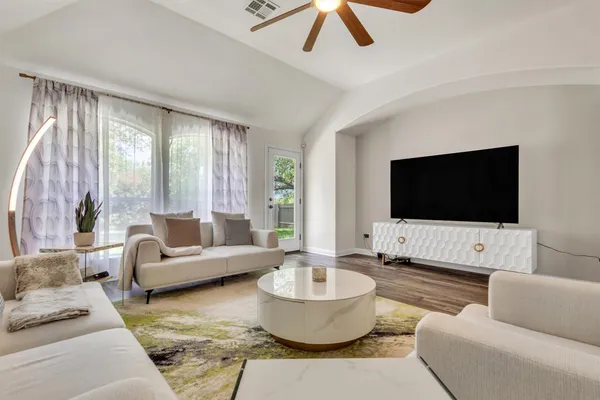 a living room with furniture and a flat screen tv