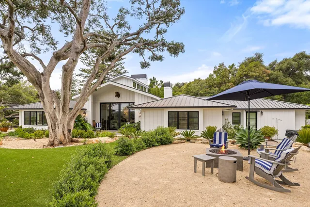 a view of a house with backyard sitting area and garden