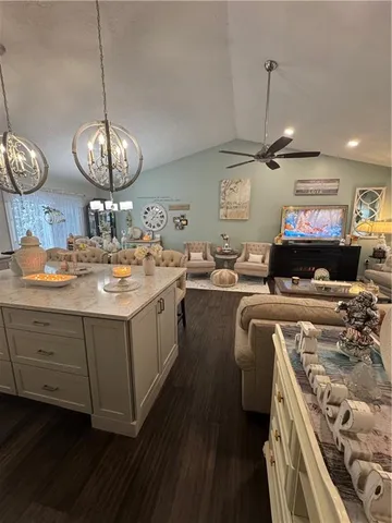 a kitchen with a stove a counter space a sink and cabinets