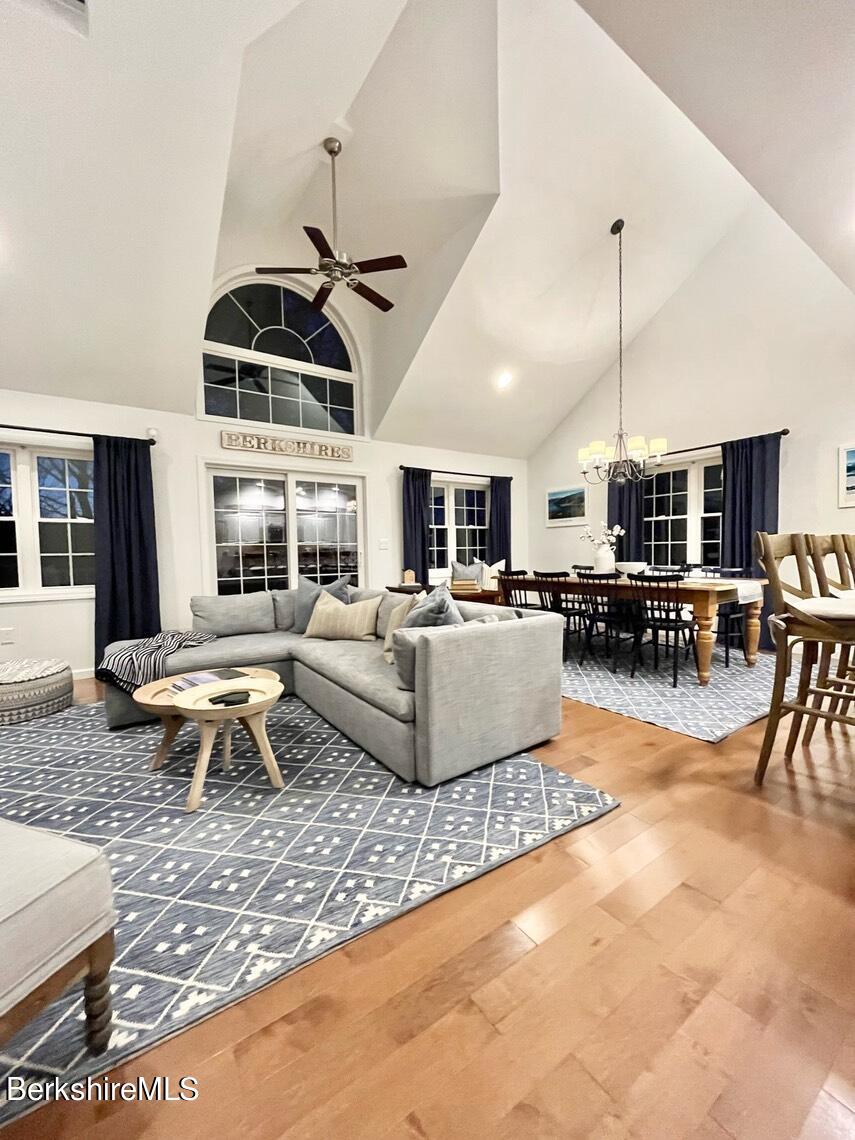 9212 Mountainside Drive Hancock, MA 01237 - Photo 13 of 44 a living room with furniture a rug kitchen view and a chandelier