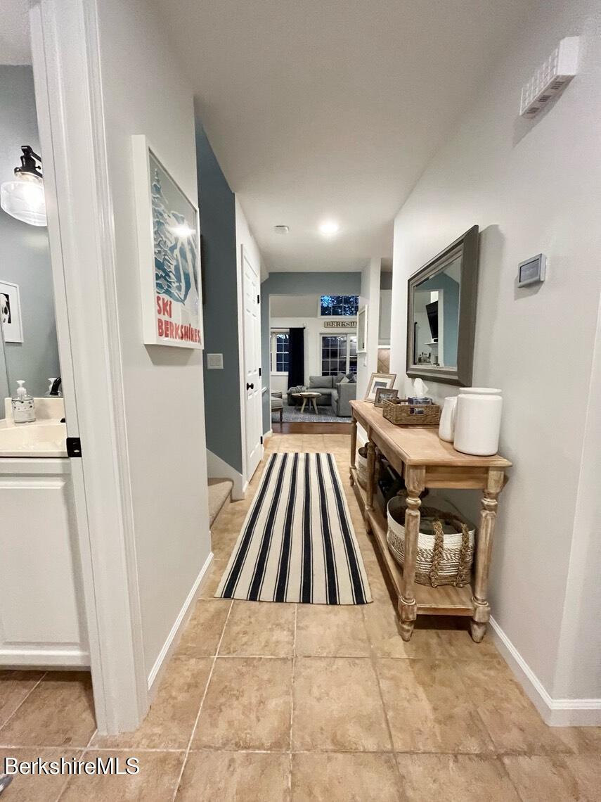9212 Mountainside Drive Hancock, MA 01237 - Photo 2 of 44 a living room with a couch and a fireplace