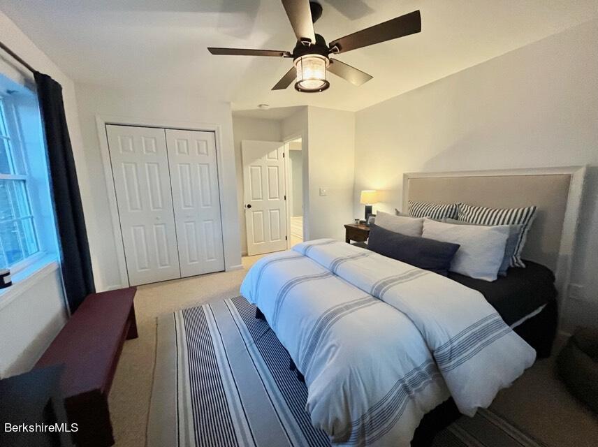 9212 Mountainside Drive Hancock, MA 01237 - Photo 29 of 44 a bedroom with a bed and a mirror