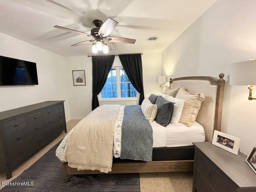 9212 Mountainside Drive Hancock, MA 01237 - Photo 30 of 44 a bedroom with a bed and a flat screen tv