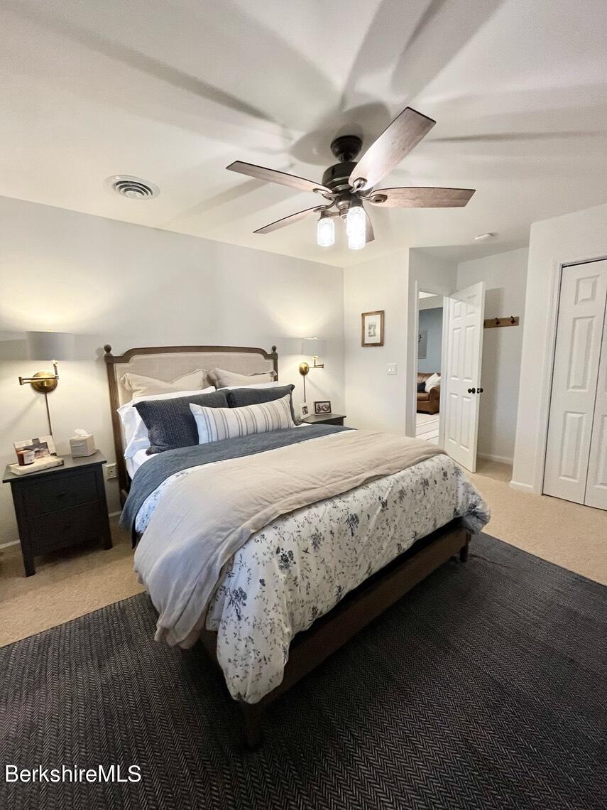 9212 Mountainside Drive Hancock, MA 01237 - Photo 31 of 44 a bedroom with bed and a chandelier