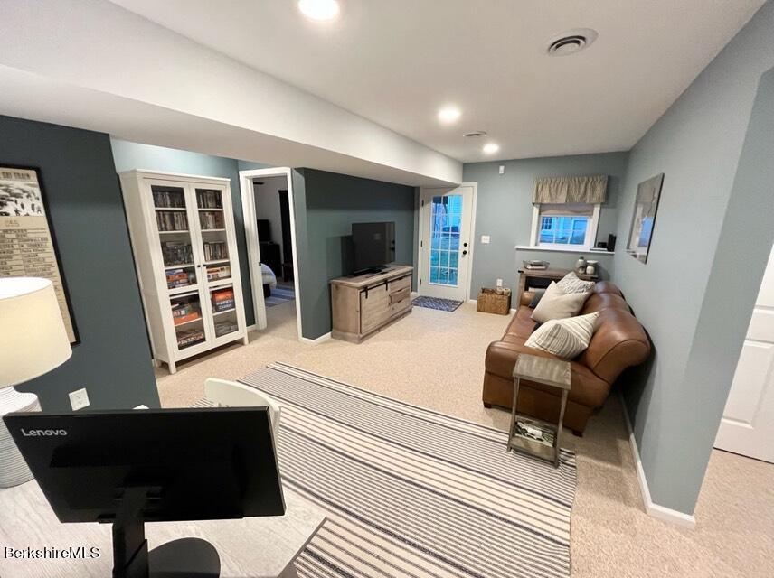 9212 Mountainside Drive Hancock, MA 01237 - Photo 33 of 44 a living room with furniture and a flat screen tv