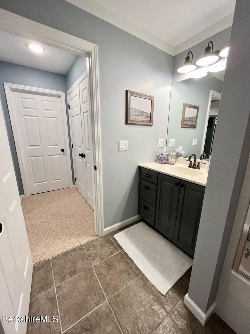 9212 Mountainside Drive Hancock, MA 01237 - Photo 37 of 44 a room with a sink a mirror and a toilet