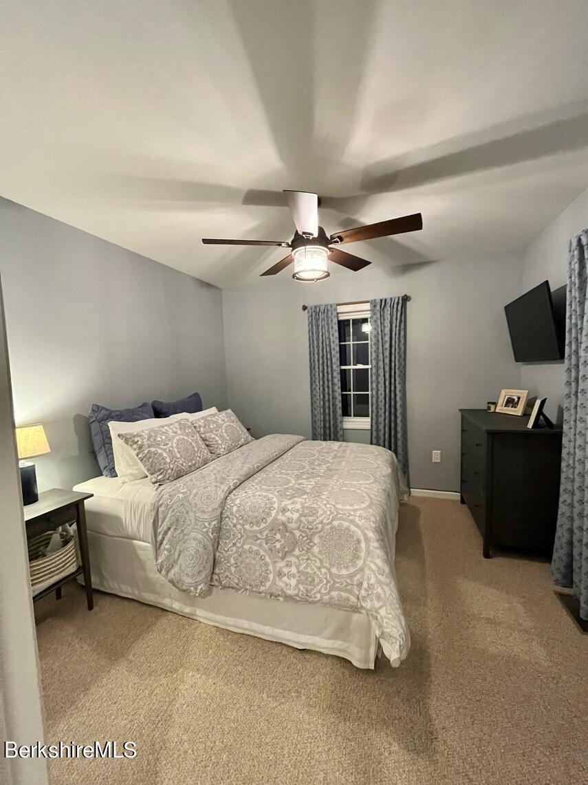 9212 Mountainside Drive Hancock, MA 01237 - Photo 4 of 44 a spacious bedroom with a bed and a flat screen tv
