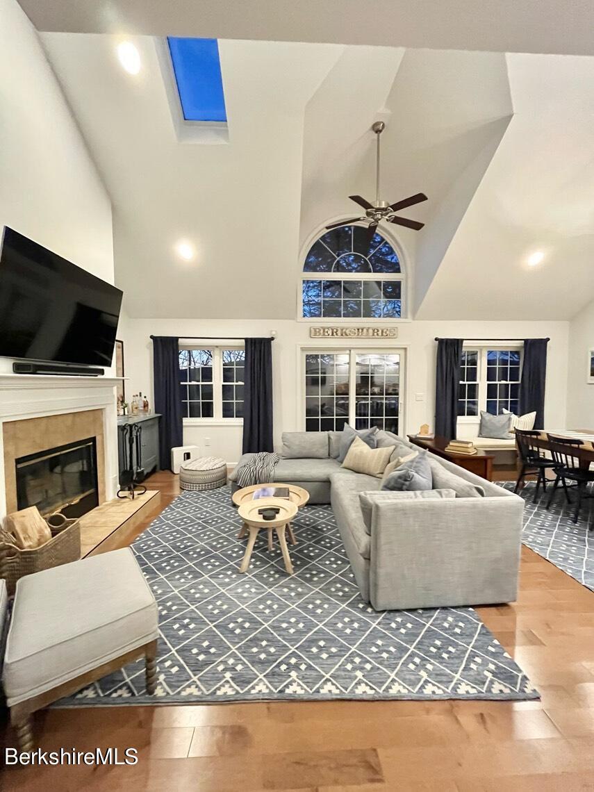 9212 Mountainside Drive Hancock, MA 01237 - Photo 9 of 44 a living room with furniture a flat screen tv and a fireplace