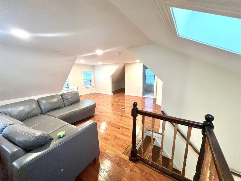277 Whitwell Street, Unit 2 Quincy, MA 02169 - Photo 2 of 9 a living room with furniture and a wooden floor