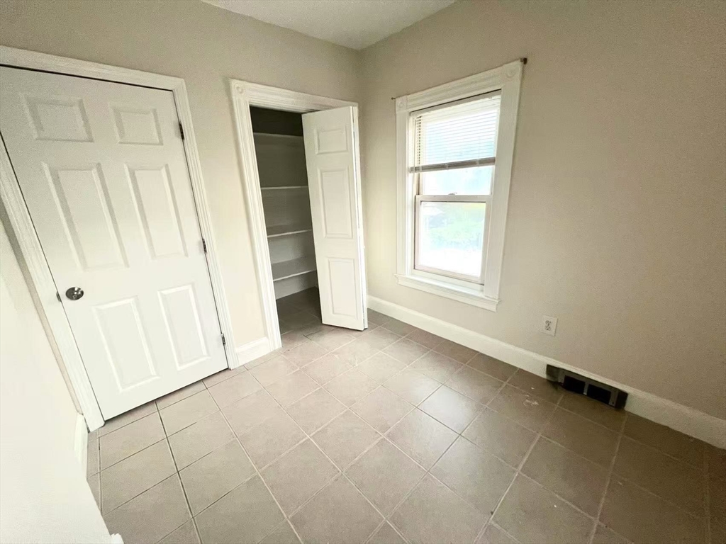 277 Whitwell Street, Unit 2 Quincy, MA 02169 - Photo 5 of 9 an empty room with windows