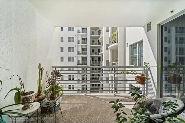 a balcony with table and chairs