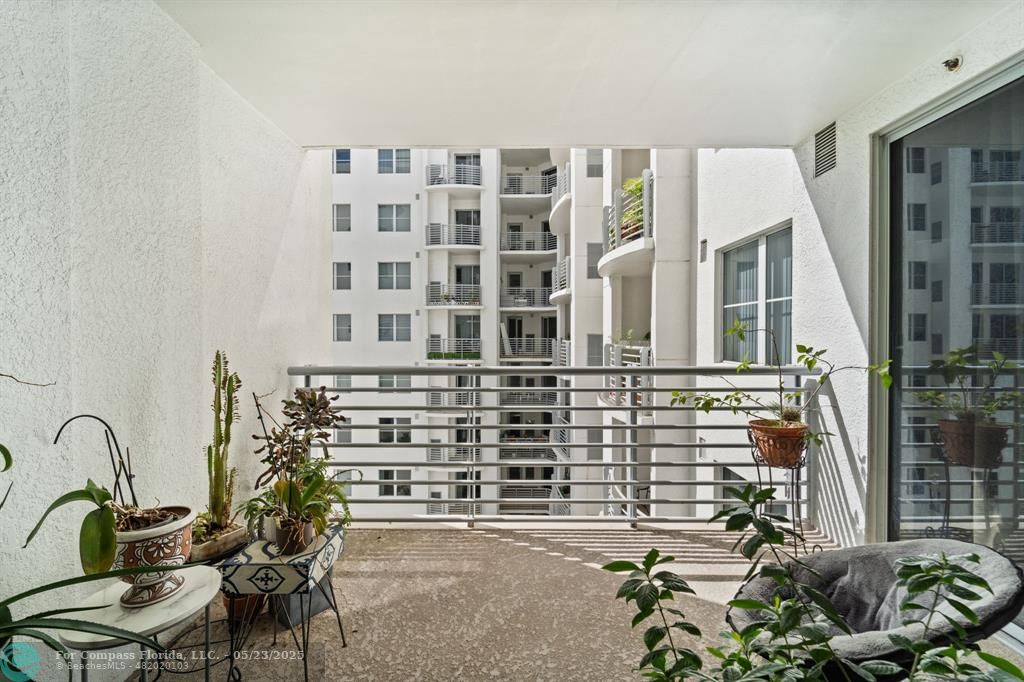 1830 Radius Drive, Unit 1017 Hollywood, FL 33020 - Photo 13 of 37 a balcony with table and chairs