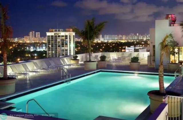 a view of a patio with swimming pool and sitting area