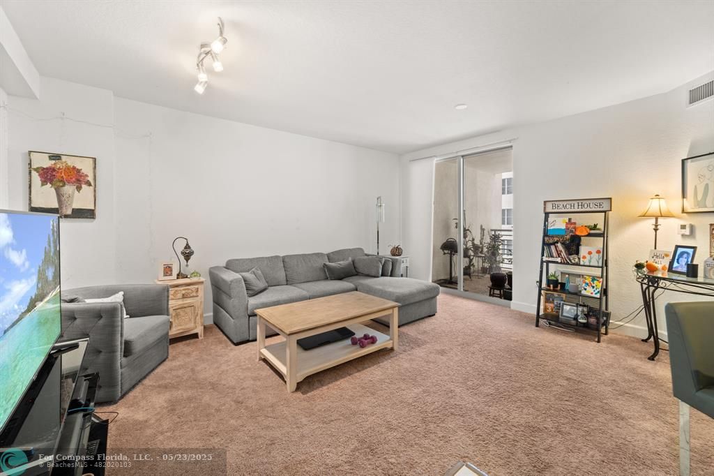 1830 Radius Drive, Unit 1017 Hollywood, FL 33020 - Photo 3 of 37 a living room with furniture and a couch