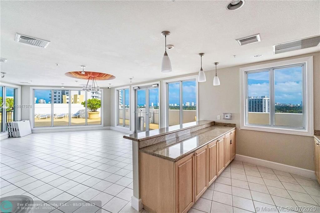 1830 Radius Drive, Unit 1017 Hollywood, FL 33020 - Photo 34 of 37 a large white kitchen with a large window