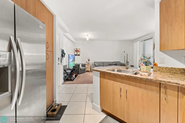 a kitchen with a sink appliances and cabinets
