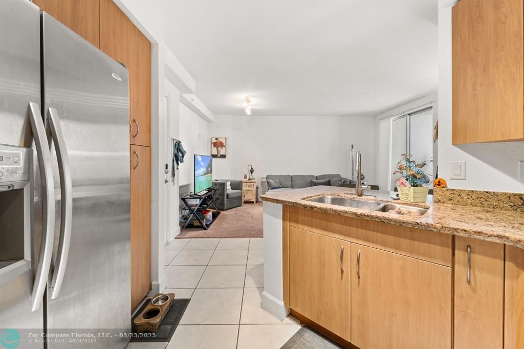 1830 Radius Drive, Unit 1017 Hollywood, FL 33020 - Photo 5 of 37 a kitchen with a sink appliances and cabinets