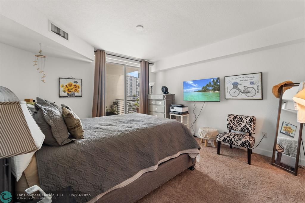 1830 Radius Drive, Unit 1017 Hollywood, FL 33020 - Photo 9 of 37 a bedroom with a bed and furniture