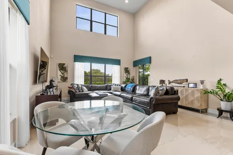 a living room with furniture gym equipment and a rug