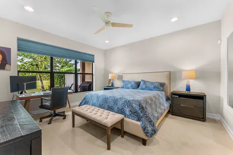 a bedroom with a bed and a workspace