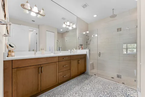 a bathroom with a granite countertop sink a toilet and shower
