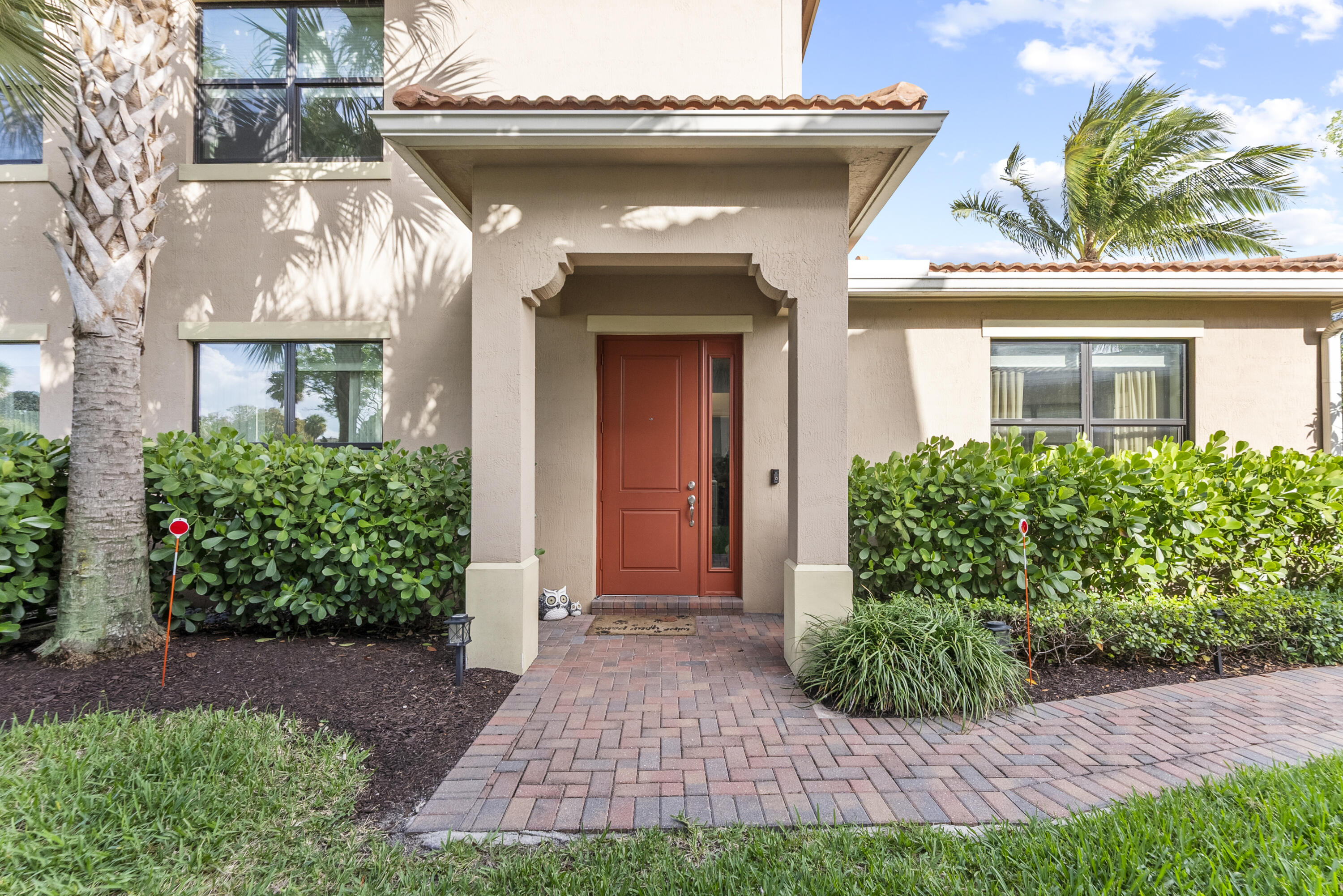 9941 Brickhill Drive Boca Raton, FL 33428 - Photo 2 of 48 a view of a house with brick walls and a yard with plants