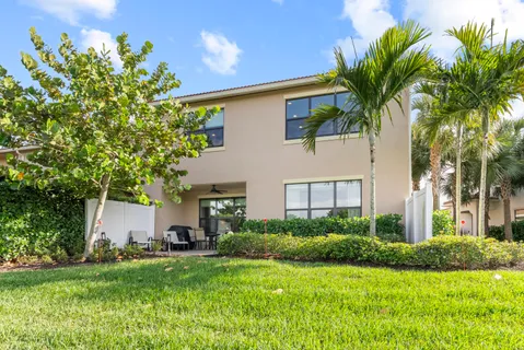 a aerial view of a house with a yard and potted plants