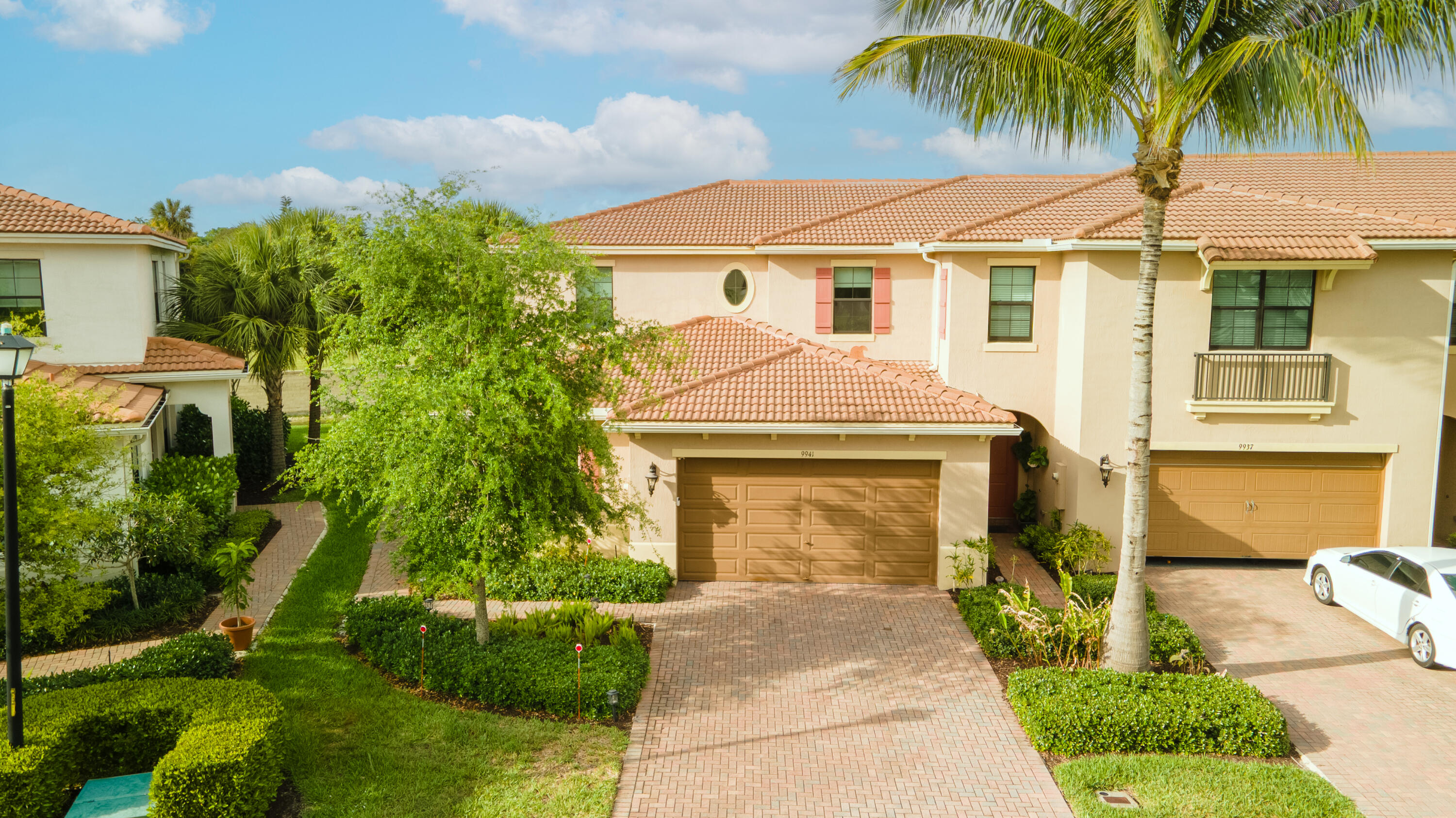9941 Brickhill Drive Boca Raton, FL 33428 - Photo 3 of 48 a front view of a house with a garden