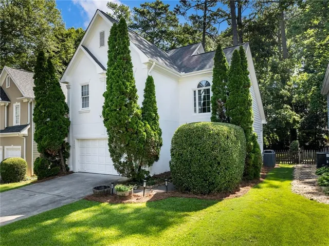 a view of a backyard with table and chairs and potted plants
