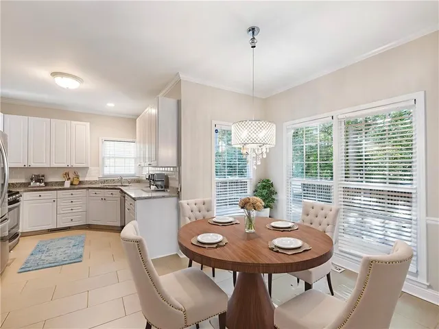 a kitchen with a table and chairs in it