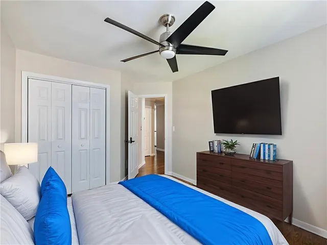 a bedroom with a bed and a flat screen tv