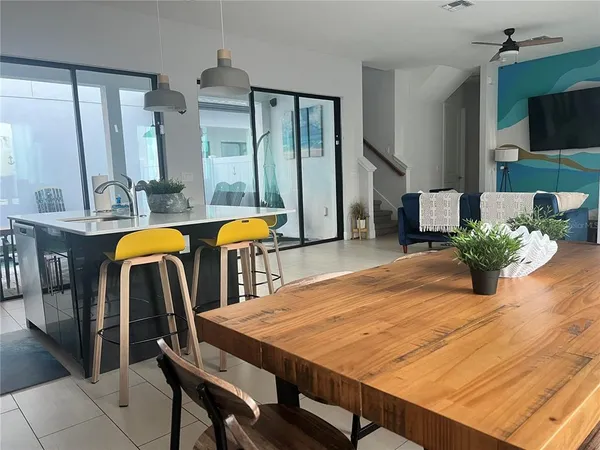a dining room with furniture and wooden floor