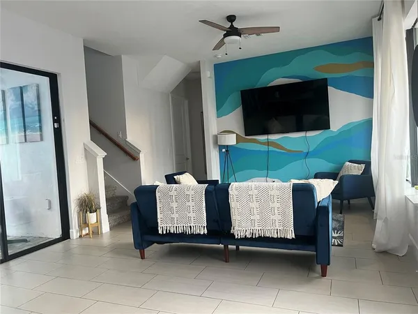 a living room with furniture and a flat screen tv