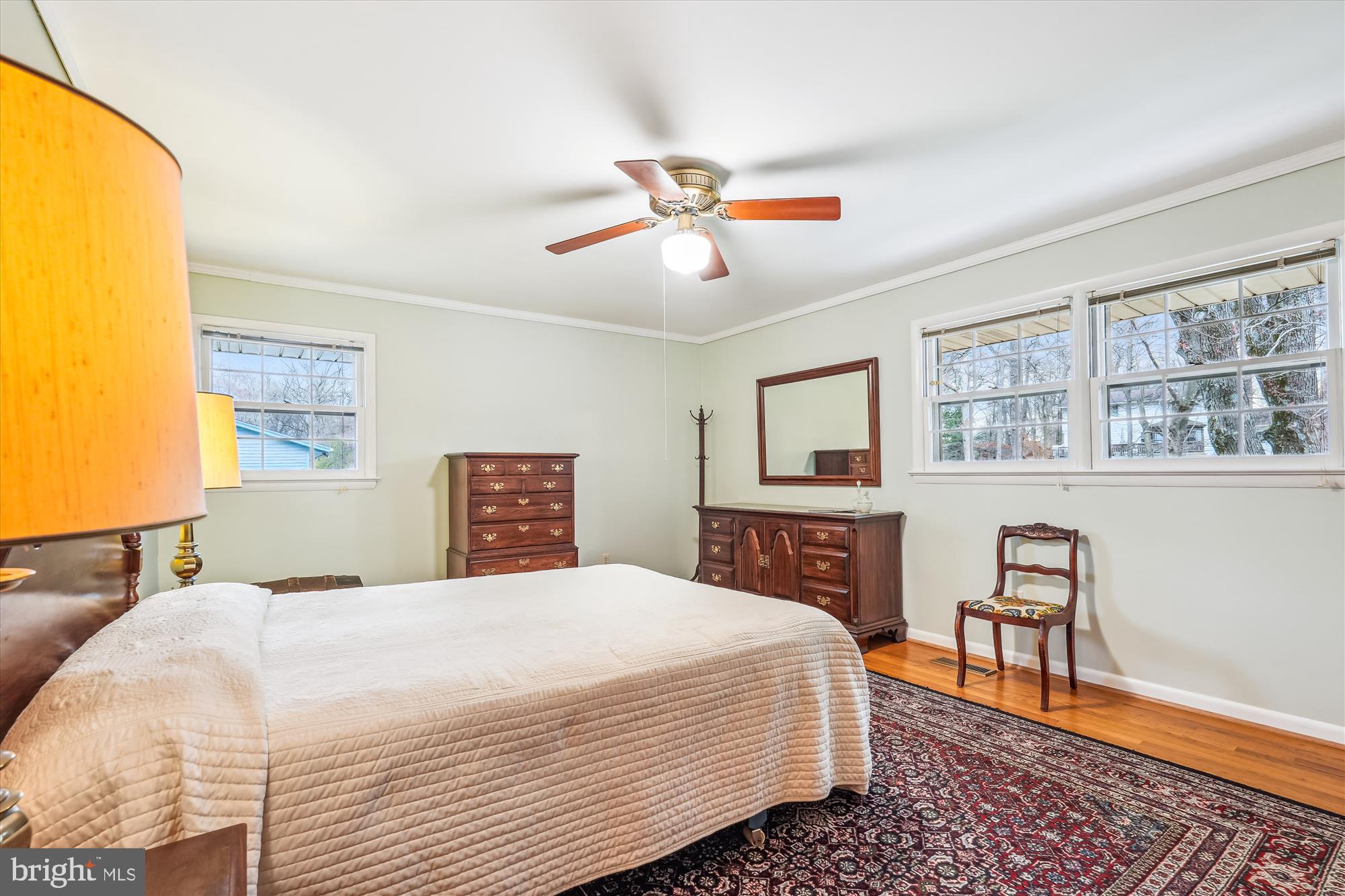 16523 Kipling Road Rockville, MD 20855 - Photo 18 of 50 a bedroom with a large bed a chandelier and dresser